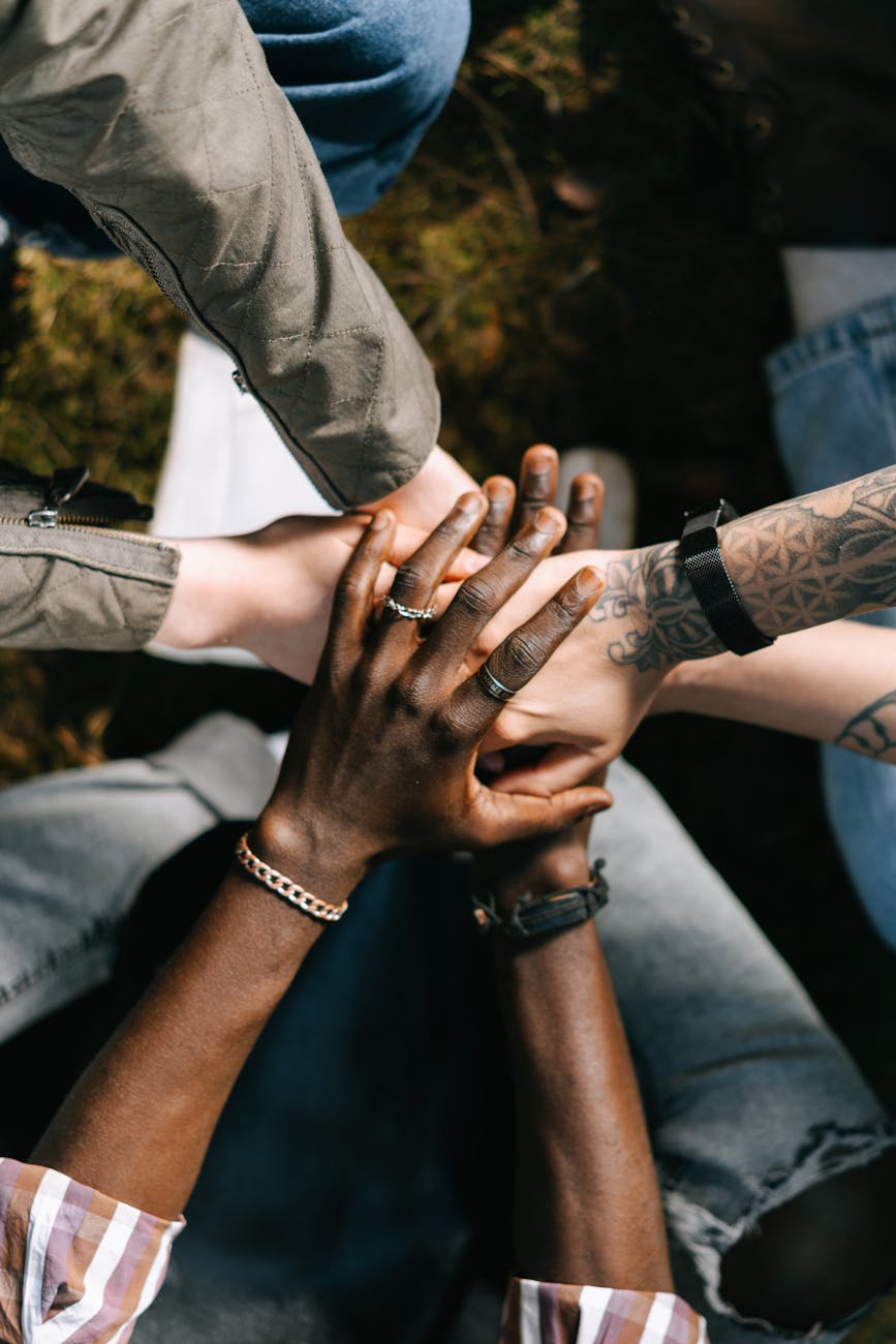 group of people putting their hands together