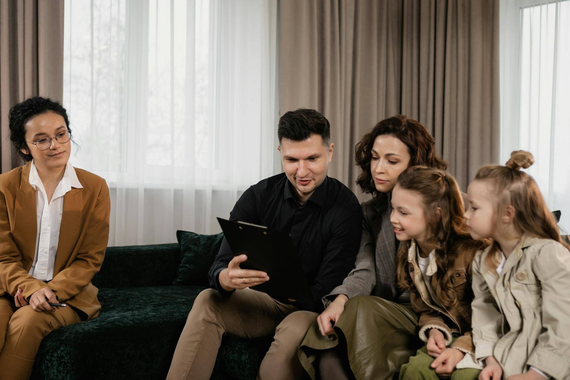 a family looking at a document on a clipboard